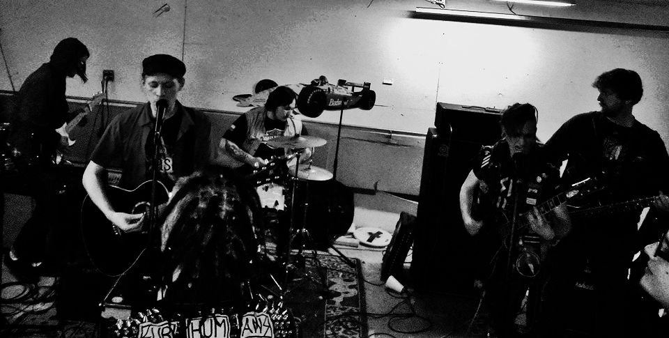 Black and white picture of 5-piece punk band. Image from first ever Davey D full band show